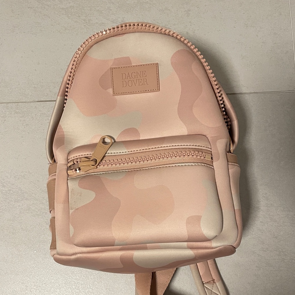 lightly used light pink camo Dange Dover mini backpack